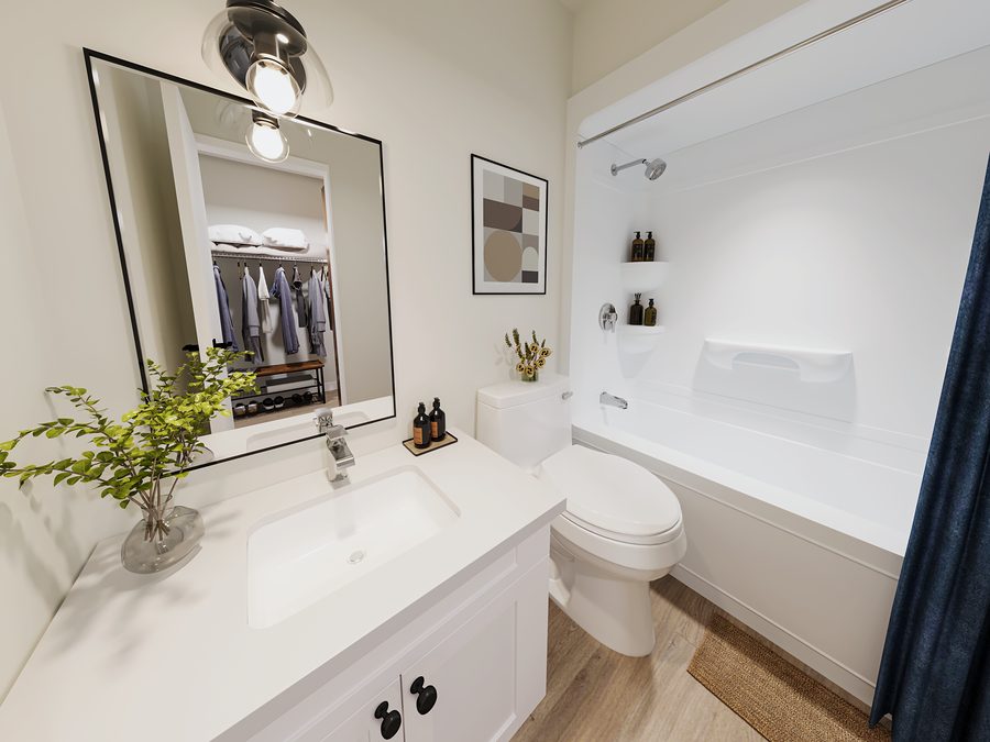 Bathroom in a 1811 John Brebeuf rental townhome with a tub and shower, black-framed mirror and white vanity
