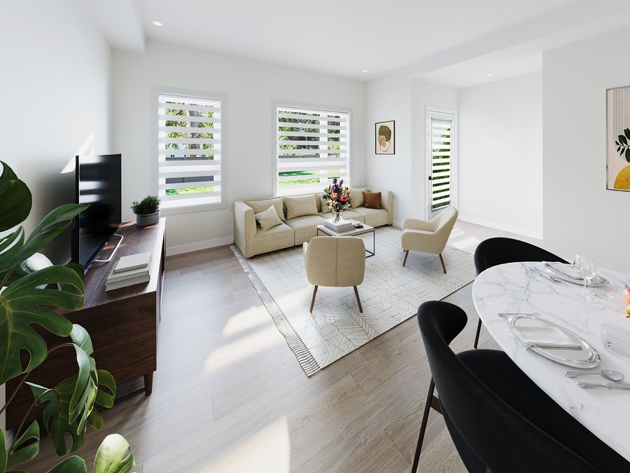 Bright living room in a 1811 John Brebeuf rental townhome with a sofa, two armchairs and two windows, dining table in the foreground